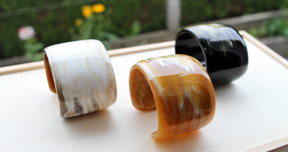 Beautiful cuffs made of natural horn in the colours white, brown and black
